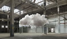 a cloud is floating in an empty warehouse