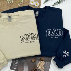 Embroidery Gift for New Mom and New Dad Celebrate parenthood with our Custom Embroidery Mama Sweatshirt and Daddy Hoodie set! Perfect for matching outfits, these personalized hoodies make thoughtful gifts for new parents-to-be. Ideal for welcoming a new mom or dad into the journey of parenthood. 💞 Product and Brand Details   ABOUT STYLE SHIRT - T-shirt is short sleeve - Crewneck same sweatshirt is not hood - Hoodie with hood ➤ Gildan ® brand ➤ Unisex & Classic fit ➤ 8 oz./yd² (US) 13.3 oz./L yd Mom And Dad Sweatshirts, Matching Embroidery, Dad Sweater, Mama Crewneck, Mama Cloth, New Dad Gift, Sweater Ideas, Dad Shirts, Papa Shirt