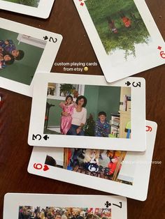 playing cards with family pictures on them sitting on a table in front of the camera