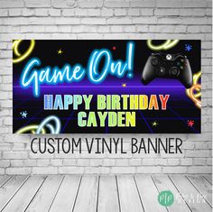 a video game birthday banner on a brick wall