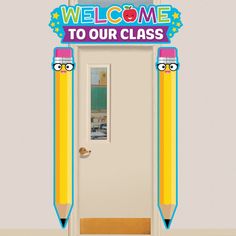 a welcome to our class sign with two pencils sticking out of the front door