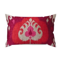 a red and white pillow with an ornate design on the front, sitting on a white background