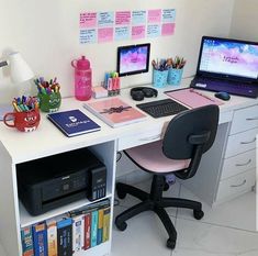 a desk with a computer, printer and other office supplies on it's top