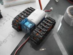 an image of a robot that is on the table with some wires attached to it