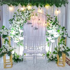 a wedding ceremony setup with white flowers and greenery