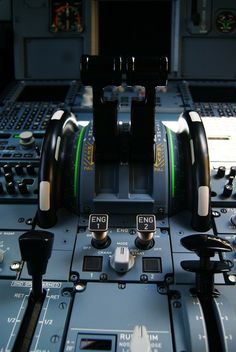 the control panel of an airplane with buttons and knobs on it's sides