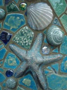 a starfish, seashells and shells on a mosaic tile background