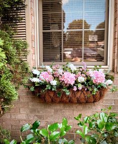 a window box filled with pink and white flowers