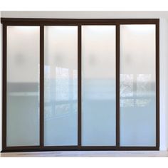 an open window with frosted glass on the outside and inside, in front of a white wall