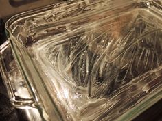 a glass dish filled with ice on top of a stove