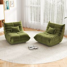 two green chairs sitting on top of a white rug