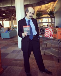 a man in a suit and tie holding a book