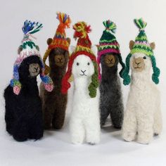 several stuffed animals wearing knitted hats and scarves