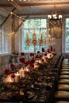 a long table is set with candles and flowers for a formal dinner or party event