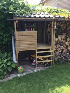 a small wooden shed with a ladder to the roof