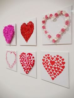 four hearts are displayed on the wall with flowers and beads attached to each one piece