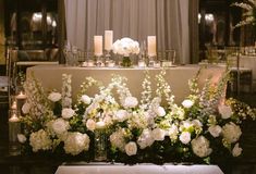 a table with flowers and candles on it