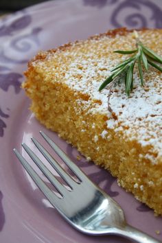 a piece of cake sitting on top of a purple plate with a fork next to it