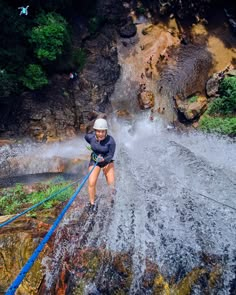 a person on water skis going over a waterfall