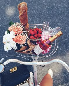 a basket filled with food and drinks on top of a bike