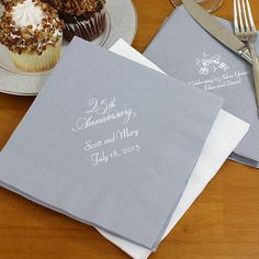 two personalized napkins sitting on top of a table next to cupcakes