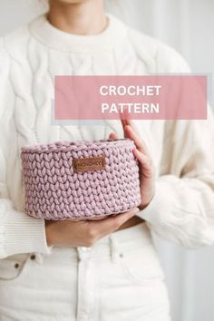 a woman holding a pink crochet basket with the words crochet pattern on it