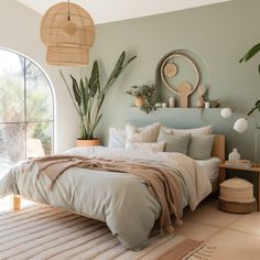 a bedroom with green walls and white bedding, potted plants on the wall