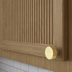 a close up of a wooden cabinet with white tile