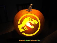 a pumpkin carved to look like a game of thrones logo with a dinosaur on it