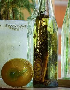 an orange sitting on top of a wooden table next to two bottles filled with liquid