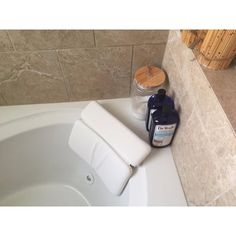 a bathtub with soap and lotion in it