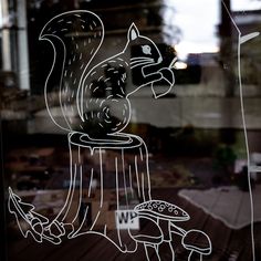 a glass window with a drawing of a squirrel on it