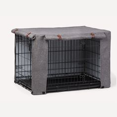 a dog crate with a cover over it's top that is made out of grey fabric