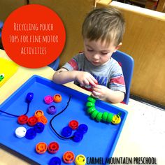 a young boy is playing with some toys