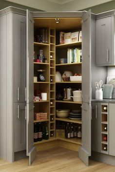 an open pantry with lots of items in the cupboards and shelves on both sides