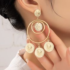 Double Hoop Drop Earrings with Dangling Coins. Add a touch of elegance and charm to your look with the Double Hoop Drop Earrings with Dangling Coins. Product Features: Stylish Design: Features double hoops adorned with playful dangling coins for a chic and dynamic look. Premium Material: Made from durable iron with shiny gold plating for a luxurious finish. Perfect Size: Measuring 1.6" x 3.5", these earrings are the ideal statement accessory to enhance any outfit. These earrings are ideal for ca Nickel Free Alloy Round Hoop Earrings, Hoop Alloy Jewelry As Gift, Hoop Alloy Jewelry Gift, Gold Hoop Earrings In Alloy, Gold Alloy Hoop Earrings, Gold Dangle Hoop Earrings In Alloy, Gold Hoop Jewelry Made Of Alloy, Gold Hoop Jewelry In Alloy, Gold Hoop Alloy Jewelry