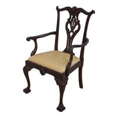 an old fashioned chair with a cushion on it's back and armrests