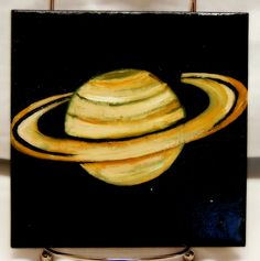 a painting of saturn with rings painted on it's black back ground and white background