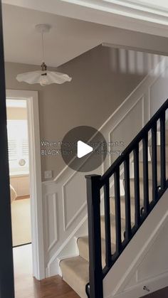 the stairs in this house are painted white and have black railings on each side