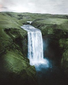 an aerial view of a waterfall in the middle of nowhere