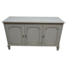 a white cabinet with four doors and two drawers