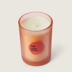 a pink candle sitting on top of a white table