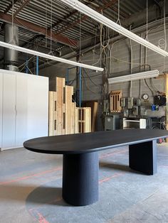 a large black table sitting inside of a warehouse