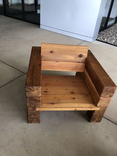 a wooden bench sitting on top of a cement floor