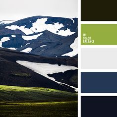 the mountains are covered in snow and green, blue, and gray hues with white accents