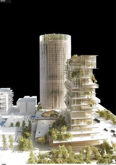 an architectural model of a tall building with trees around it