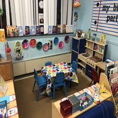 a child's playroom with toys and books on the shelves, including desks