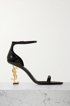 There's no mistaking SAINT LAURENT's 'Opyum' sandals. They've been crafted in Italy from glossy patent-leather and set on the maison's emblematic, antiqued gold-tone heels. Perfect for city nights, they'll take you confidently from dates to glamorous parties. Designer Patent Leather Sandals With Sculpted Heel, Luxury Patent Leather Sandals With Sculpted Heel, Luxury Sandals With Sculpted Heel In Patent Leather, Luxury Sandals With Patent Leather And Single Toe Strap, Latest Sandal, Embellished Shoes, Glamorous Party, Brown Leather Sandals, Embellished Sandals