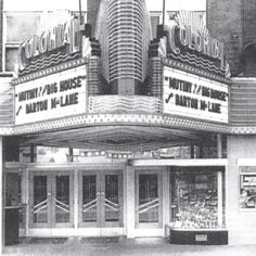 an old movie theater with the marquee in black and white