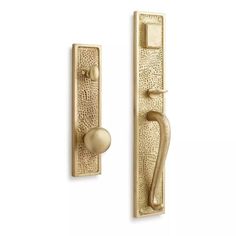 an antique brass door handle and knob on the side of a white wall with a gold finish